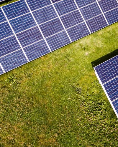 5404985-drone-view-aerial-view-solar-panel-electricity-green-issues-field-grass-nature-environment-energy-outdoors-sunlight-blue-gra-green-drone-above-sun-panel-solar-free-pictures